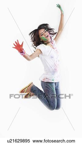 Stock Photography - Woman with coloured palms jumping. Fotosearch
