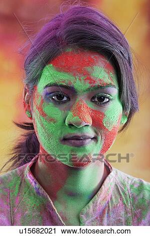 Stock Image - Woman's face covered in holi colours. Fotosearch