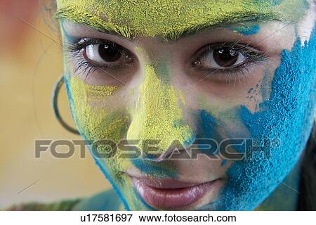 Stock Photo - Woman's face covered in holi colours. Fotosearch