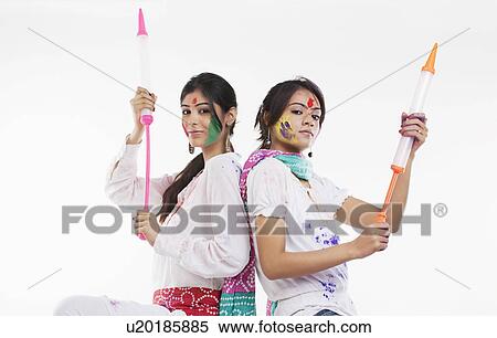 Stock Photography - Women holding pichkaris. Fotosearch