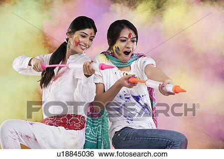 Women playing holi with pichkaris View Large Photo Image Stock Photograph - Women playing holi with pichkaris. Fotosearch