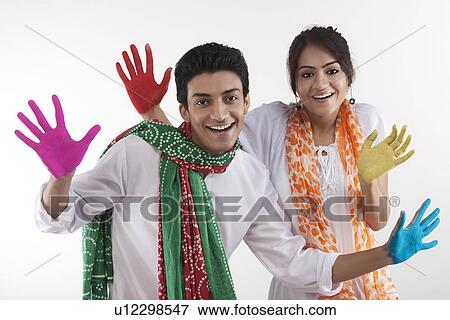 Stock Photo - Young couple with coloured palms. Fotosearch
