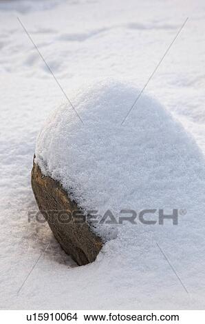a boulder covered with snow View Large Photo Image Picture - a boulder covered with snow. Fotosearch