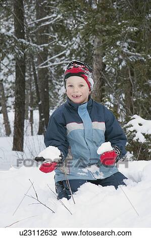 Boy holding a snowball View Large Photo Image Stock Image - Boy holding a snowball. Fotosearch