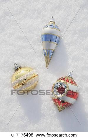 Stock Photo - Christmas ornaments in snow. Fotosearch