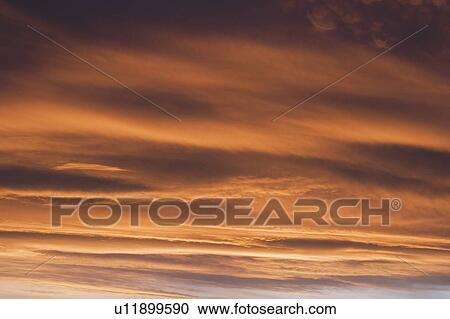 Stock Image - Clouds at sunset. Fotosearch