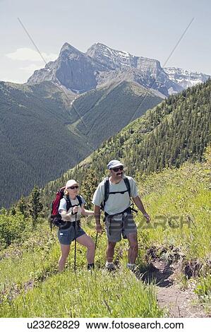 Stock Photo - Couple hiking trail on Centennial Ridge, Kananaskis Country, Alberta, Canada. Fotosearch