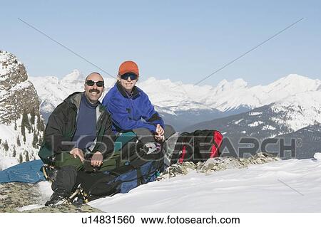 Couple sitting on the top of a mountain View Large Photo Image Stock Image - Couple sitting on the top of a mountain. Fotosearch