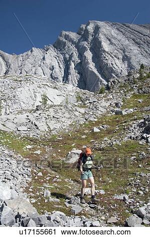 Stock Image - Female hiker on rocky trail, Kananaskis Country, Alberta, Canada. Fotosearch