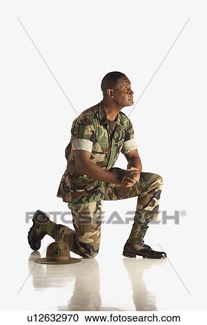 Stock Image - fort lauderdale, florida, united states of america; a military man down on one knee. Fotosearch
