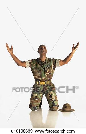 Stock Photo - fort lauderdale, florida, united states of america; a military man with arms in the air and looking upwards. Fotosearch