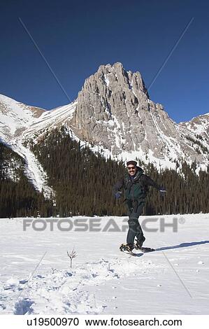 Stock Image - Man in snowshoes in the mountains. Fotosearch