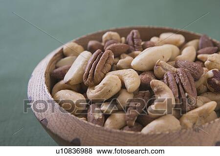 Stock Photo - mixed nuts in a wooden bowl. Fotosearch