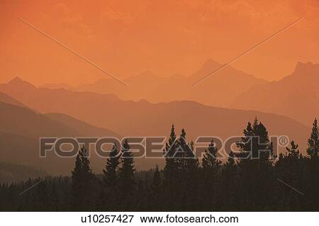 Silhouette of mountain ranges and orange sky View Large Photo Image Stock Photo - Silhouette of mountain ranges and orange sky. Fotosearch