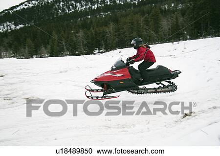 Stock Image - Snowmobile in the air. Fotosearch