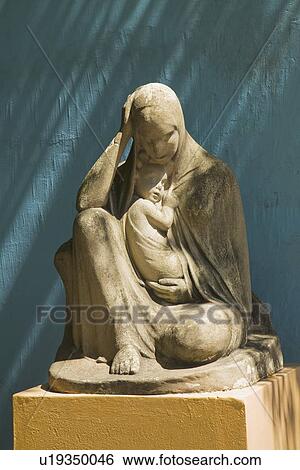 Stock Photograph - stone statue of the virgin mary holding jesus, buenos aires, argentina. Fotosearch
