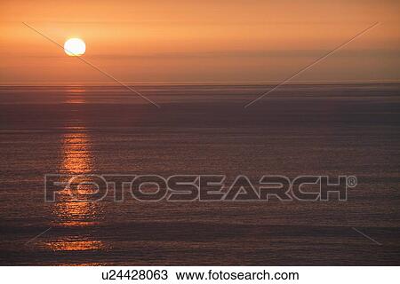 Stock Image - sun over the ocean. Fotosearch