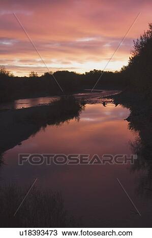 Stock Image - Sunrise over Sheep River, Alberta, Canada. Fotosearch