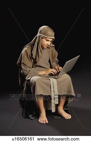 young jesus using a laptop View Large Photo Image Stock Image - young jesus using a laptop. Fotosearch