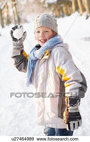 Stock Photo - Boy About To Throw Snowball In Snowy Woodland. Fotosearch