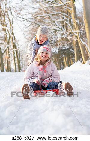 Boy And Girl Sledging Through Snowy Woodland View Large Photo Image Stock Photo - Boy And Girl Sledging Through Snowy Woodland. Fotosearch