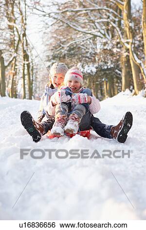 Boy And Girl Sledging Through Snowy Woodland View Large Photo Image Stock Photograph - Boy And Girl Sledging Through Snowy Woodland. Fotosearch