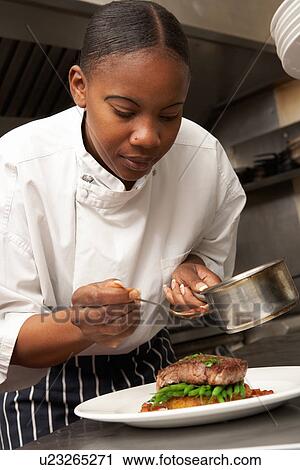 Chef Adding Sauce To Dish In Restaurant Kitchen View Large Photo Image Stock Image - Chef Adding Sauce To Dish In Restaurant Kitchen. Fotosearch