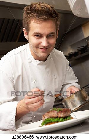 Chef Adding Sauce To Dish In Restaurant Kitchen View Large Photo Image Stock Photograph - Chef Adding Sauce To Dish In Restaurant Kitchen. Fotosearch