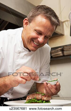Chef Adding Seasoning To Dish In Restaurant Kitchen View Large Photo Image Stock Image - Chef Adding Seasoning To Dish In Restaurant Kitchen. Fotosearch