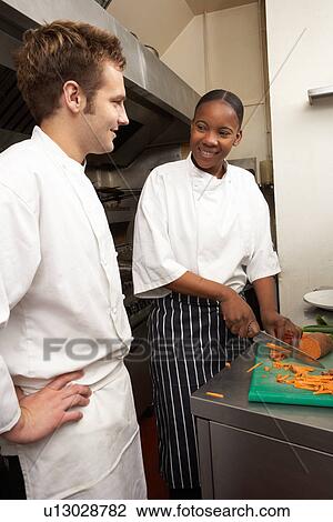 Chef Instructing Trainee In Restaurant Kitchen View Large Photo Image Stock Image - Chef Instructing Trainee In Restaurant Kitchen. Fotosearch