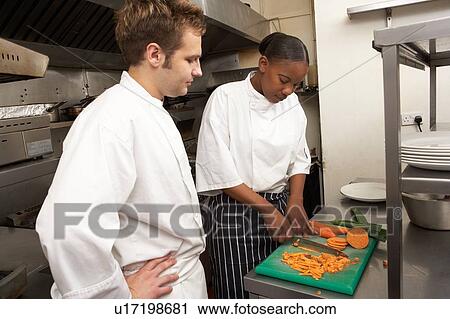 Chef Instructing Trainee In Restaurant Kitchen View Large Photo Image Stock Image - Chef Instructing Trainee In Restaurant Kitchen. Fotosearch
