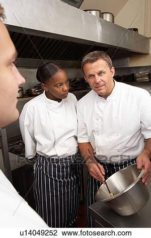 Chef Instructing Trainees In Restaurant Kitchen View Large Photo Image Stock Image - Chef Instructing Trainees In Restaurant Kitchen. Fotosearch