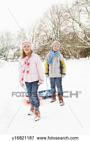 Children Pulling Sledge Through Snowy Landscape View Large Photo Image Stock Photo - Children Pulling Sledge Through Snowy Landscape. Fotosearch