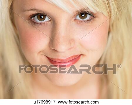 Stock Photo - Close Studio Portrait Of Blonde Teenage Girl. Fotosearch
