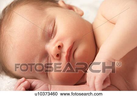 Stock Image - Close Up Of Baby Sleeping On Towel. Fotosearch