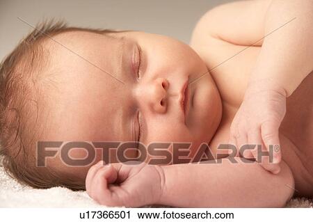 Stock Image - Close Up Of Baby Sleeping On Towel. Fotosearch