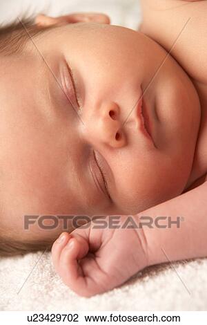 Stock Image - Close Up Of Baby Sleeping On Towel. Fotosearch