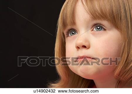 Stock Image - Close Up Studio Portrait Of Sad Young Girl. Fotosearch