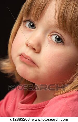 Stock Photograph - Close Up Studio Portrait Of Sad Young Girl. Fotosearch