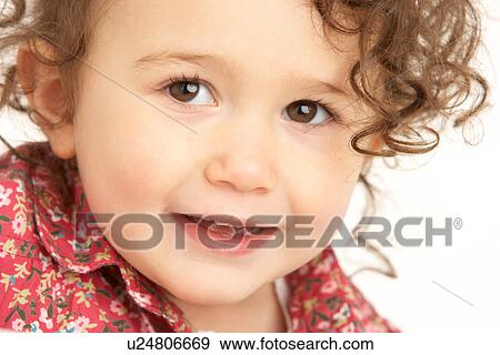 Stock Photo - Close Up Studio Portrait Of Smiling Young Girl. Fotosearch