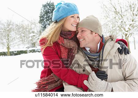 Picture - Couple Standing Outside In Snowy Landscape. Fotosearch
