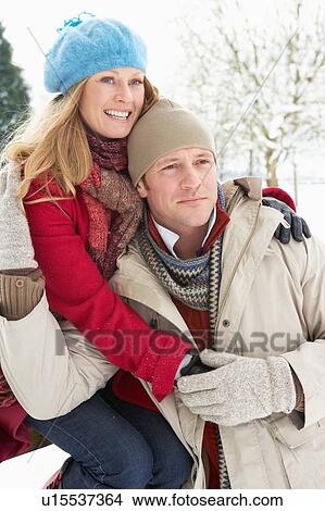 Picture - Couple Standing Outside In Snowy Landscape. Fotosearch