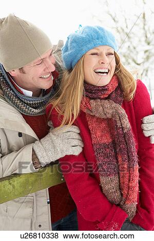 Couple Standing Outside In Snowy Landscape View Large Photo Image Stock Photo - Couple Standing Outside In Snowy Landscape. Fotosearch