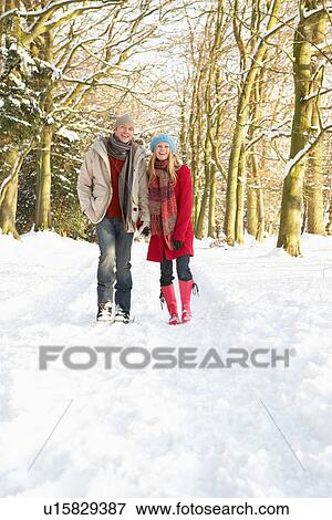 Couple Walking Through Snowy Woodland View Large Photo Image Stock Photo - Couple Walking Through Snowy Woodland. Fotosearch