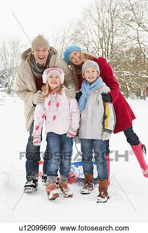 Family Pulling Sledge Through Snowy Landscape View Large Photo Image Stock Photo - Family Pulling Sledge Through Snowy Landscape. Fotosearch