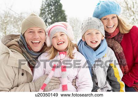 Stock Photo - Family Sitting In Snowy Landscape. Fotosearch