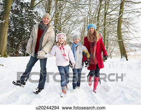 Picture - Family Walking Through Snowy Woodland. Fotosearch