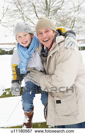 Stock Photo - Father And Son Standing Outside In Snowy Landscape. Fotosearch