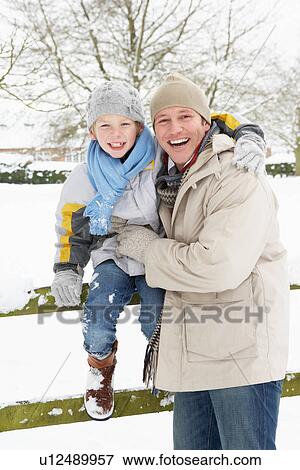 Stock Photo - Father And Son Standing Outside In Snowy Landscape. Fotosearch