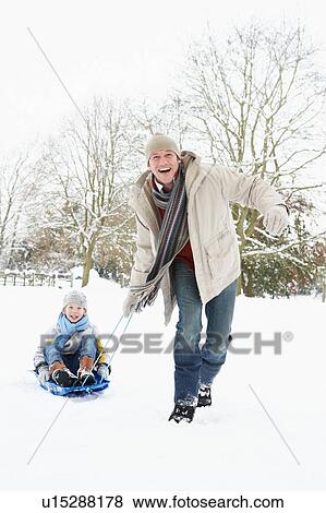 Father Pulling Son On Sledge Through Snowy Landscape View Large Photo Image Stock Photo - Father Pulling Son On Sledge Through Snowy Landscape. Fotosearch